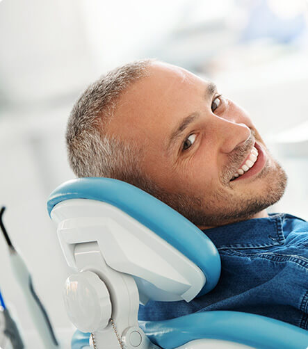 smiling an sitting in a dental chair