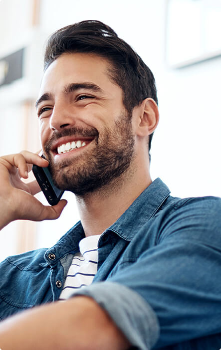 smiling man talking on his phone