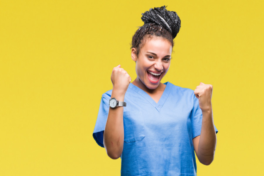 Smiling girl in front of a yellow background.